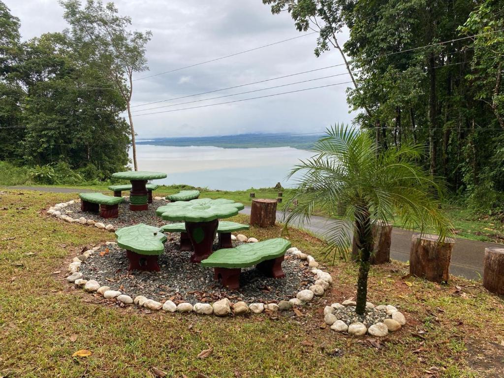 a group of picnic tables with a view of the water at Bahías Lodge in Rincón