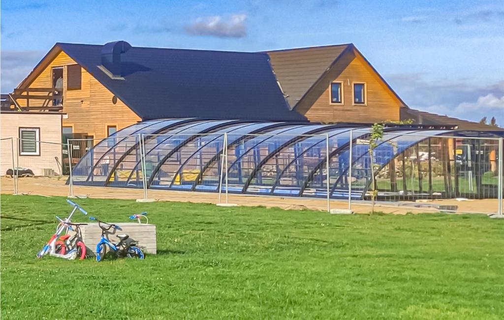 a building in a field with bikes in front of it at Stunning Apartment In Jezierzany With Kitchen in Jezierzany