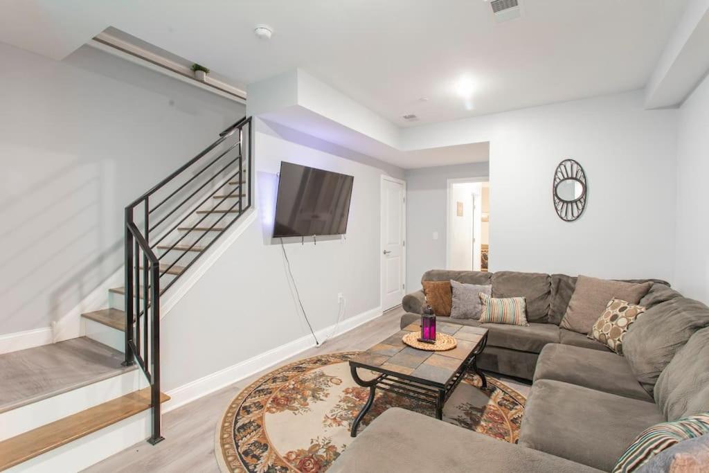 a living room with a couch and a tv at Brand New Dbl Unit Roofdeck Outdoor Patio in Philadelphia