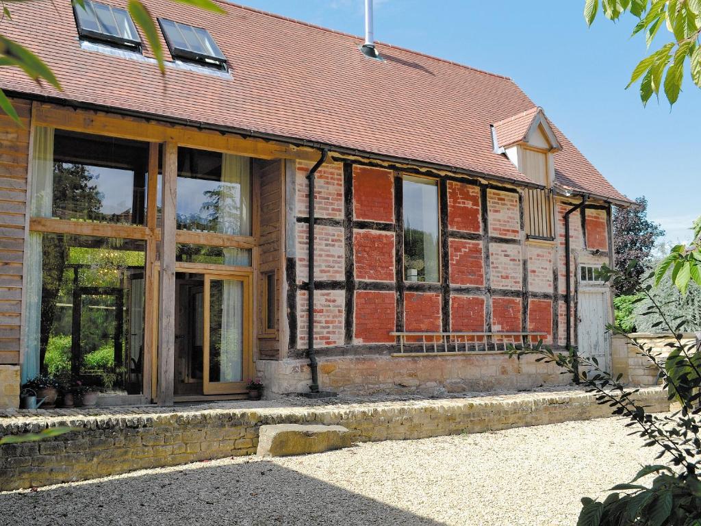 an old brick house with glass doors and windows at The Barn Reborn - Nrp in Winchcombe