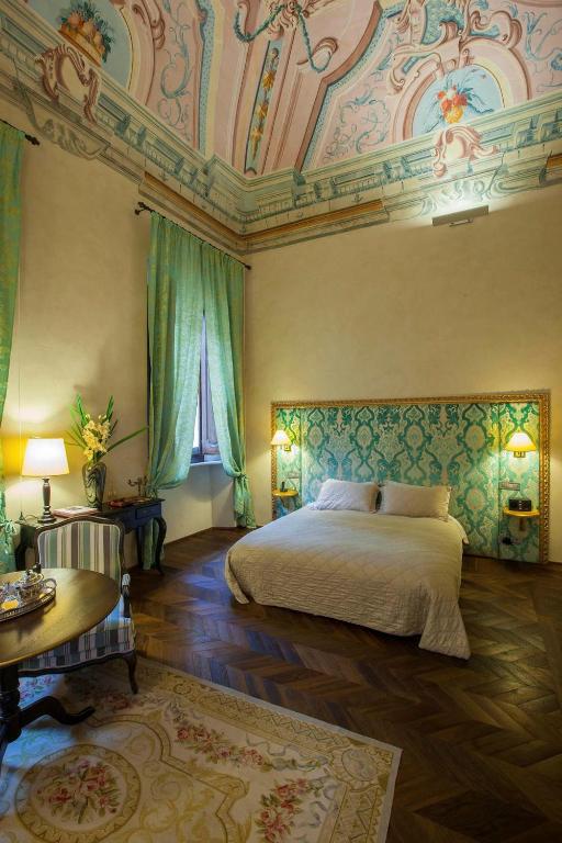 Postel nebo postele na pokoji v ubytování Palazzo Carletti
