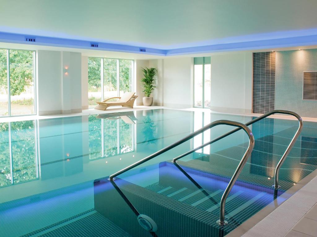 a swimming pool with a glass floor and a staircase in a house at Apartment 4 in South Cerney