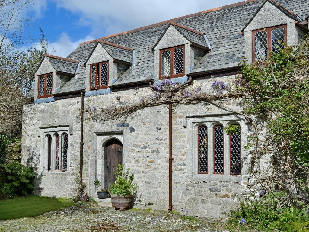 an old stone house with a gray roof at The Manor Wing in Par