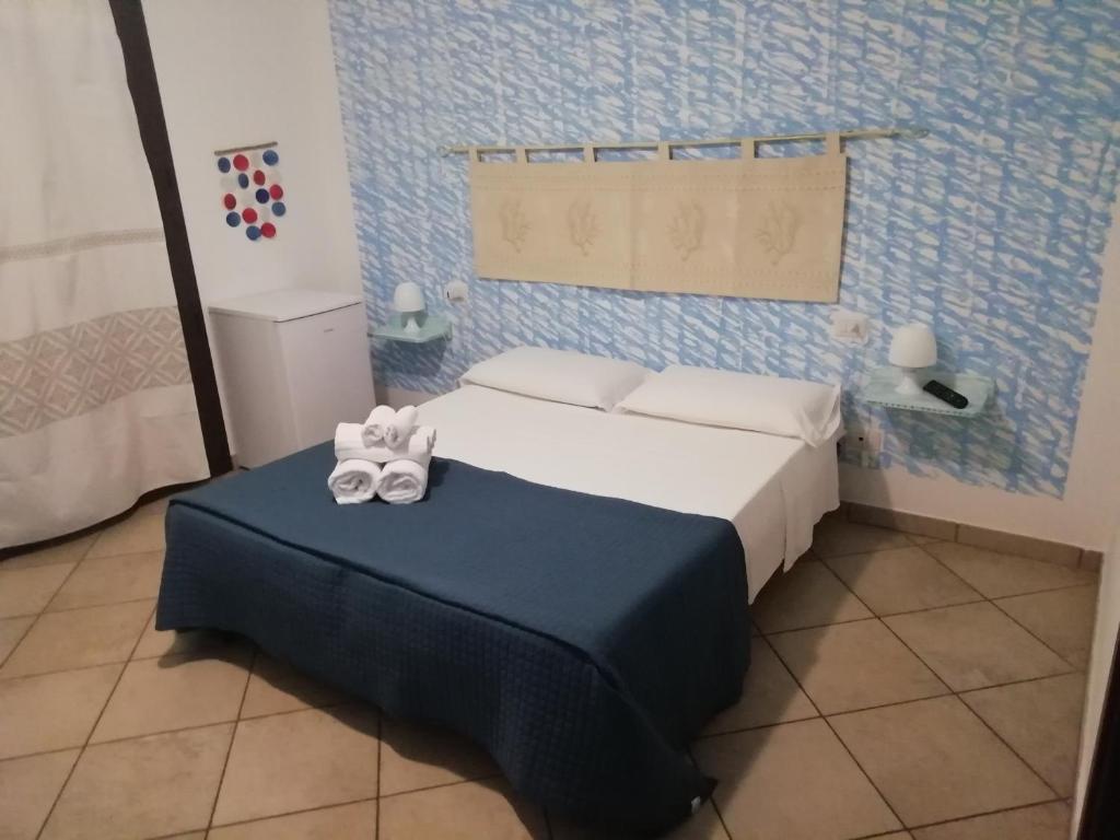 Postel nebo postele na pokoji v ubytování B&B Acquamarina Villasimius