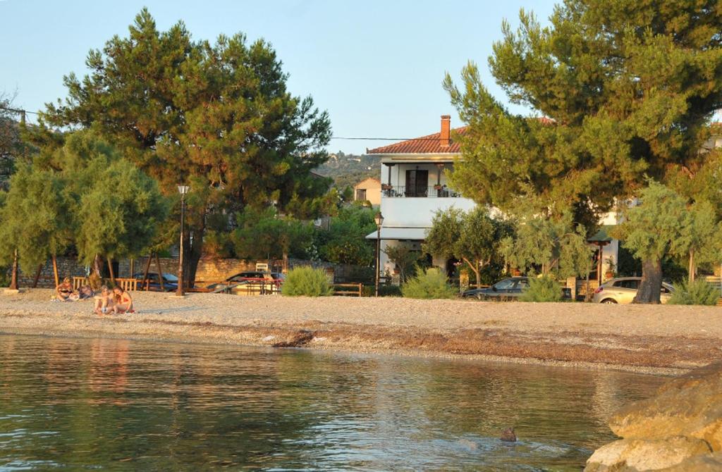 a house sitting on the shore of a body of water at Zouzoula House in Milína