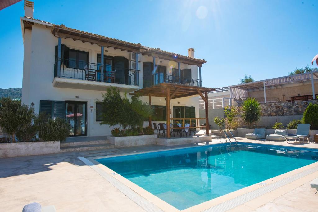 a swimming pool in front of a villa at Villa Endless Blue in Kalamitsi