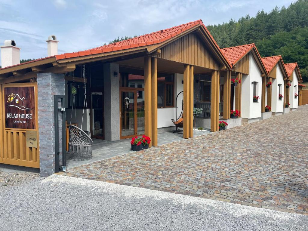 a row of small buildings with a brick road at Relax House in Praid