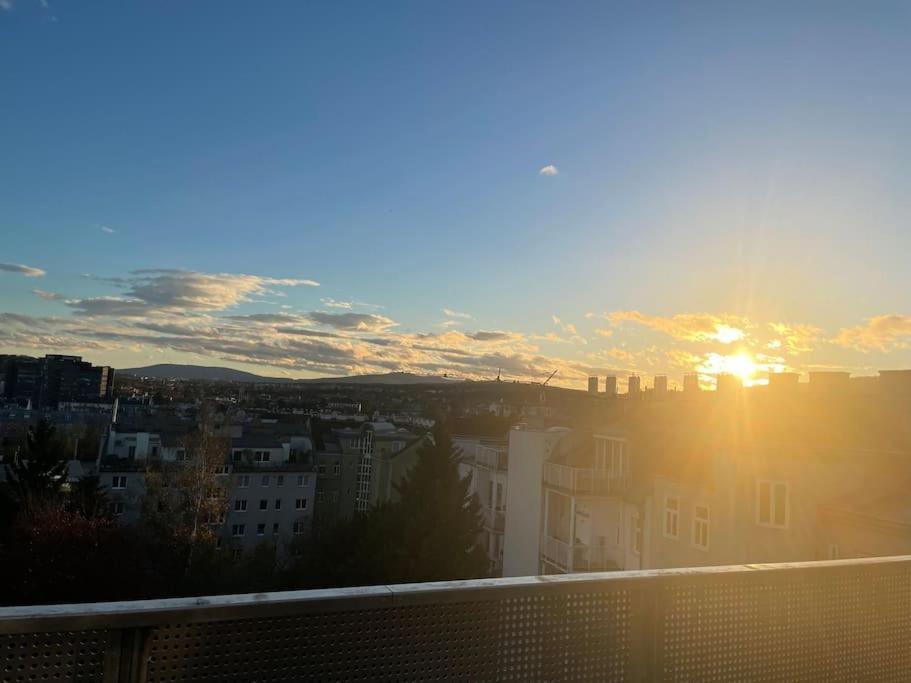 a view of the sun setting over a city at Rooftop Terrace- Panoramablick über Wien in Vienna