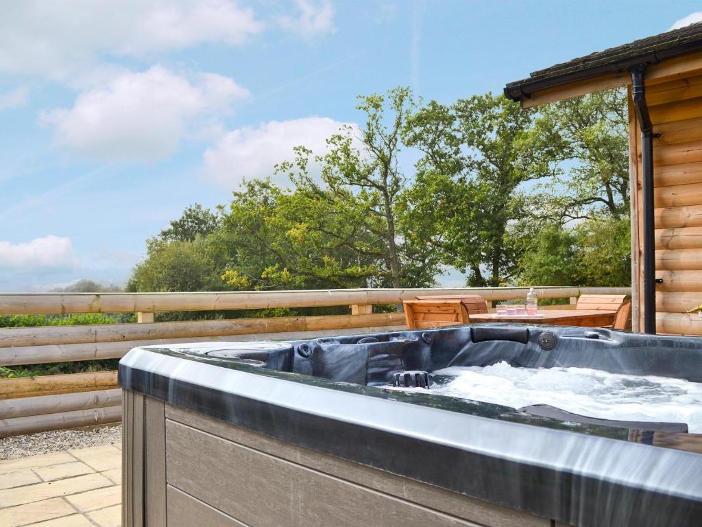 a hot tub on the deck of a house at Hillside View in Llandrindod Wells