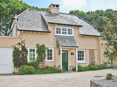 a large house with a driveway in front of it at Keepers Cottage in Helford Passage