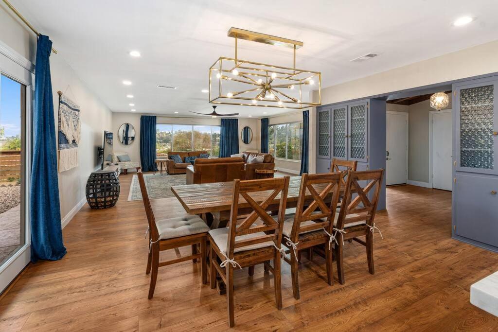 a dining room and living room with a table and chairs at Designer 4 BR La Mesa Home w/ Yard and BBQ in La Mesa