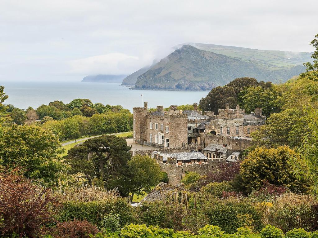 a view of a town with the ocean in the background at South Court Apt - FHP in Combe Martin