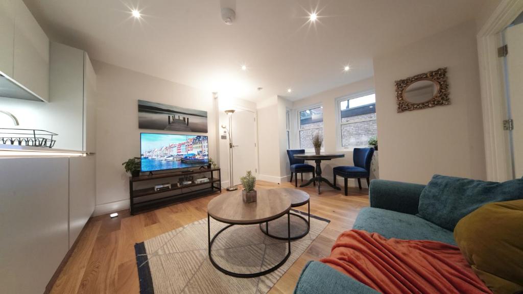 a living room with a couch and a table at Ritual Stays stylish 1-Bed Flat in the Heart of St Albans City Centre with Working Space and Super Fast WiFi in St. Albans