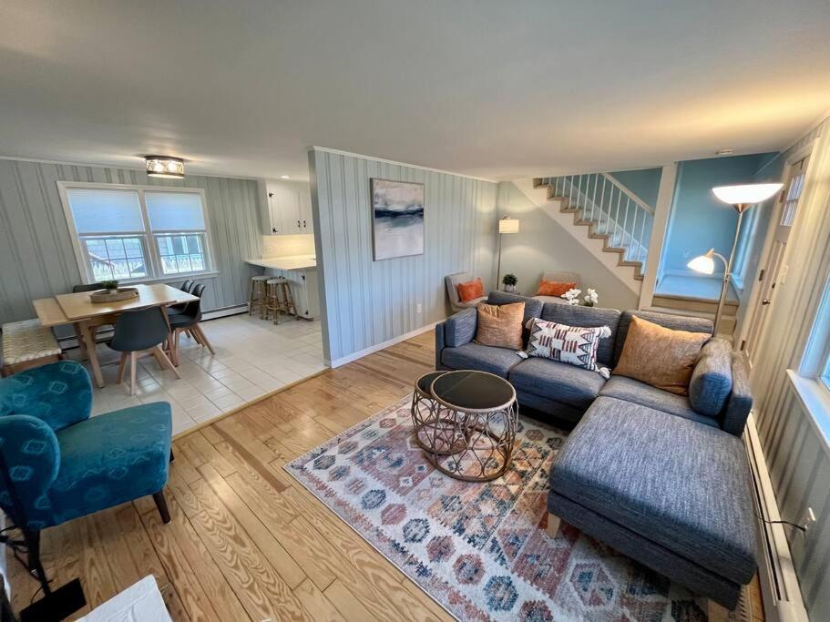 a living room with a blue couch and a table at Sunshine House steps from Beach in Seabrook