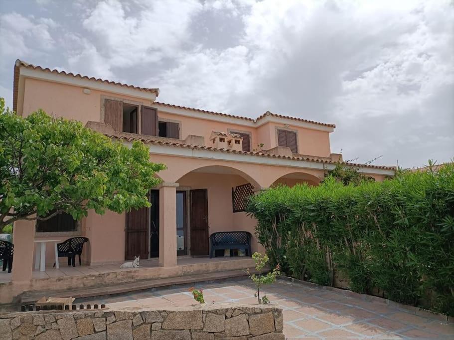 a large house with a patio in front of it at casa a pochi minuti dalla spiaggia di vignola in Vignola Mare