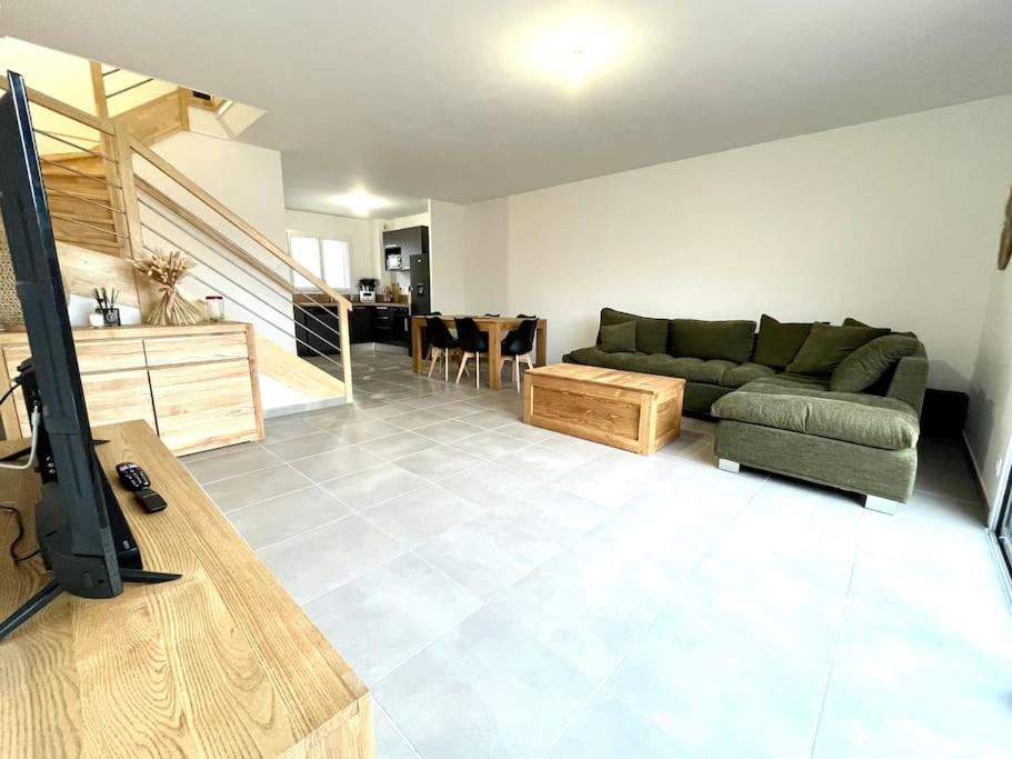 a living room with a couch and a table at Villa 8 personnes bord de mer climatisée in Saintes-Maries-de-la-Mer