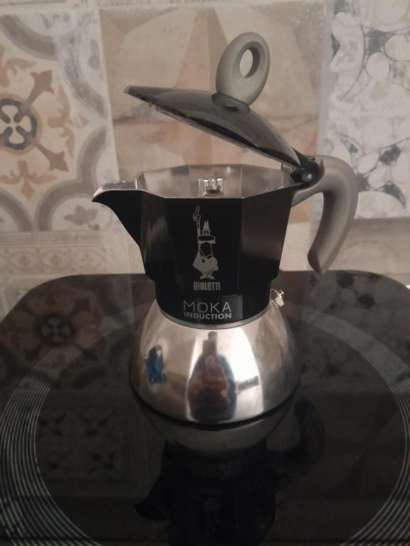 a tea kettle with a pair of scissors on top at Alloggio2 in Altamura