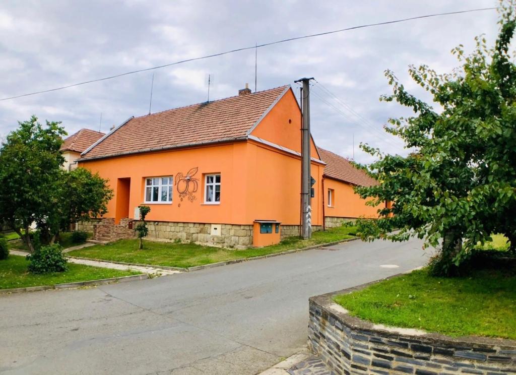 an orange house on the side of a road at Malý penzion U Meruňky 