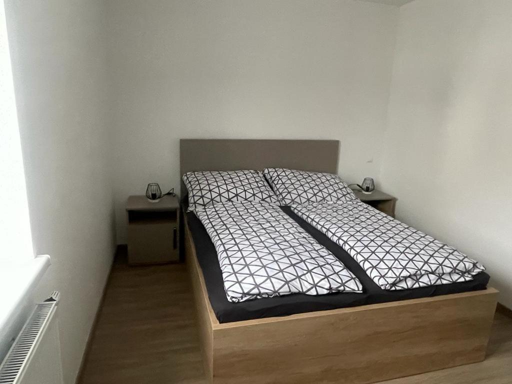 a bed in a small room with two night stands at Apartment Viktoria in Horn