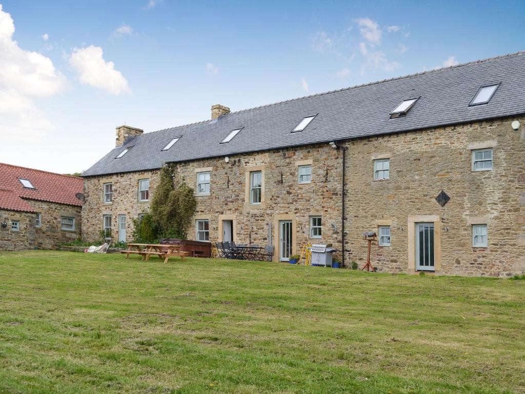 a large brick building with solar panels on it at The Farm House in Wolsingham