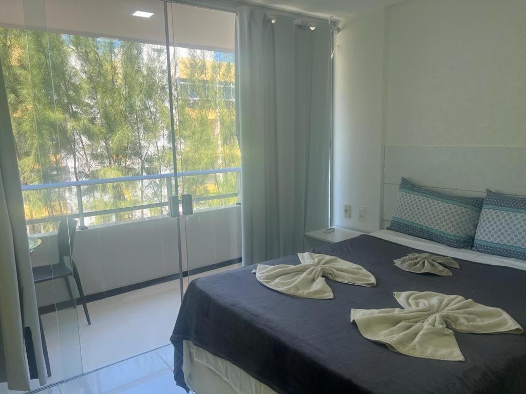 a bedroom with a bed with two towels on it at Praia dos carneiros flat hotel in Tamandaré