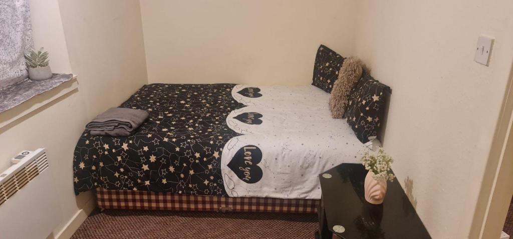 a small bedroom with a bed in a room at Modern flat in Jerviston Court in Motherwell