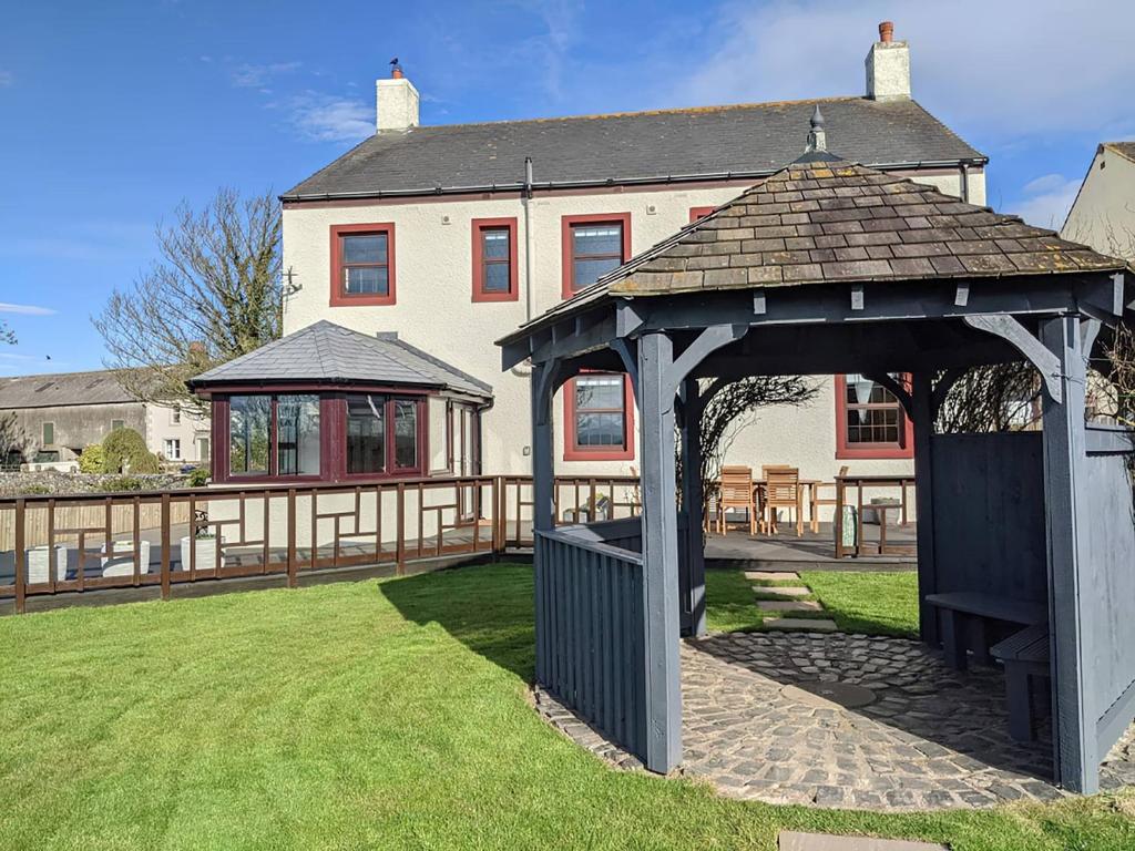 a gazebo in front of a house at Brambleside in Mawbray