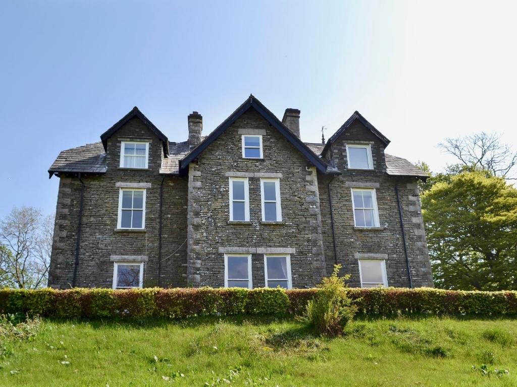 an old stone house on a grassy hill at 4 The Old Vicarage in Far Sawrey