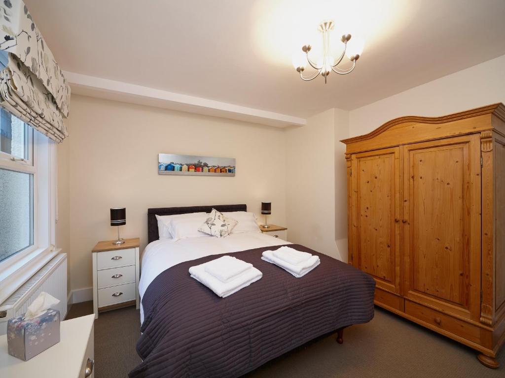 a bedroom with a bed with two towels on it at The Old Stables in Filey
