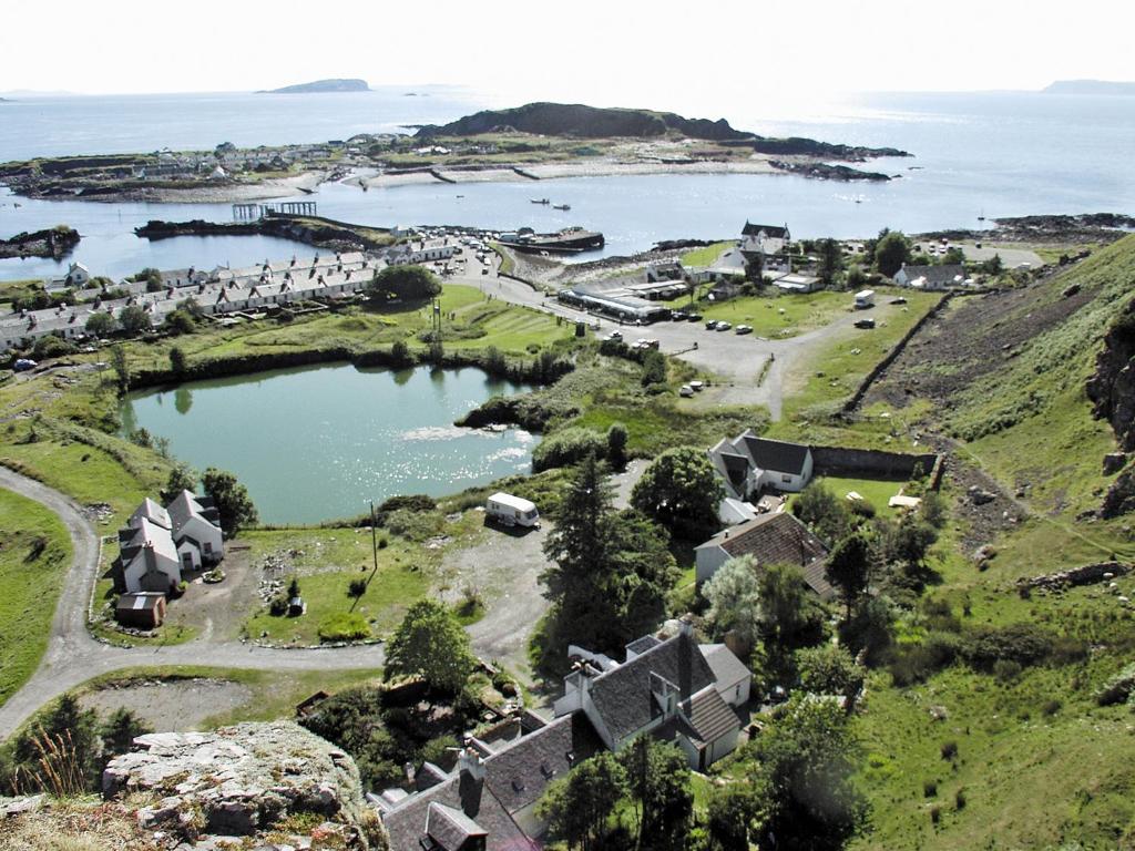 an aerial view of a village with a lake at Misty Isles Cottage - S4577 in Ellanbeich