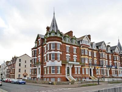 a large red brick building on a city street at Sky Lark in Cromer