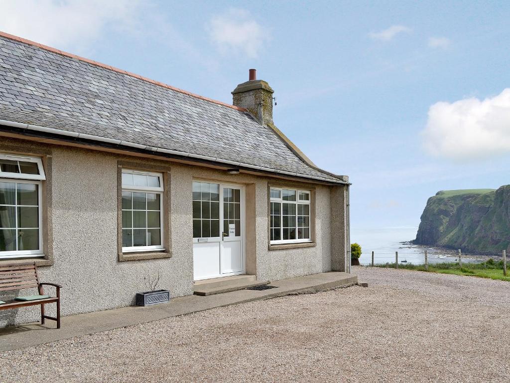 a house with a view of the ocean at Pennan Lodge - 26818 in Pennan