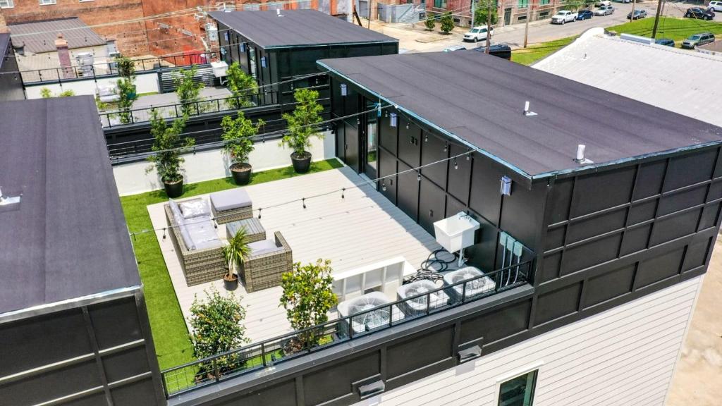 an aerial view of a building with a patio and plants at Eclipse Rooftop Villa in New Orleans