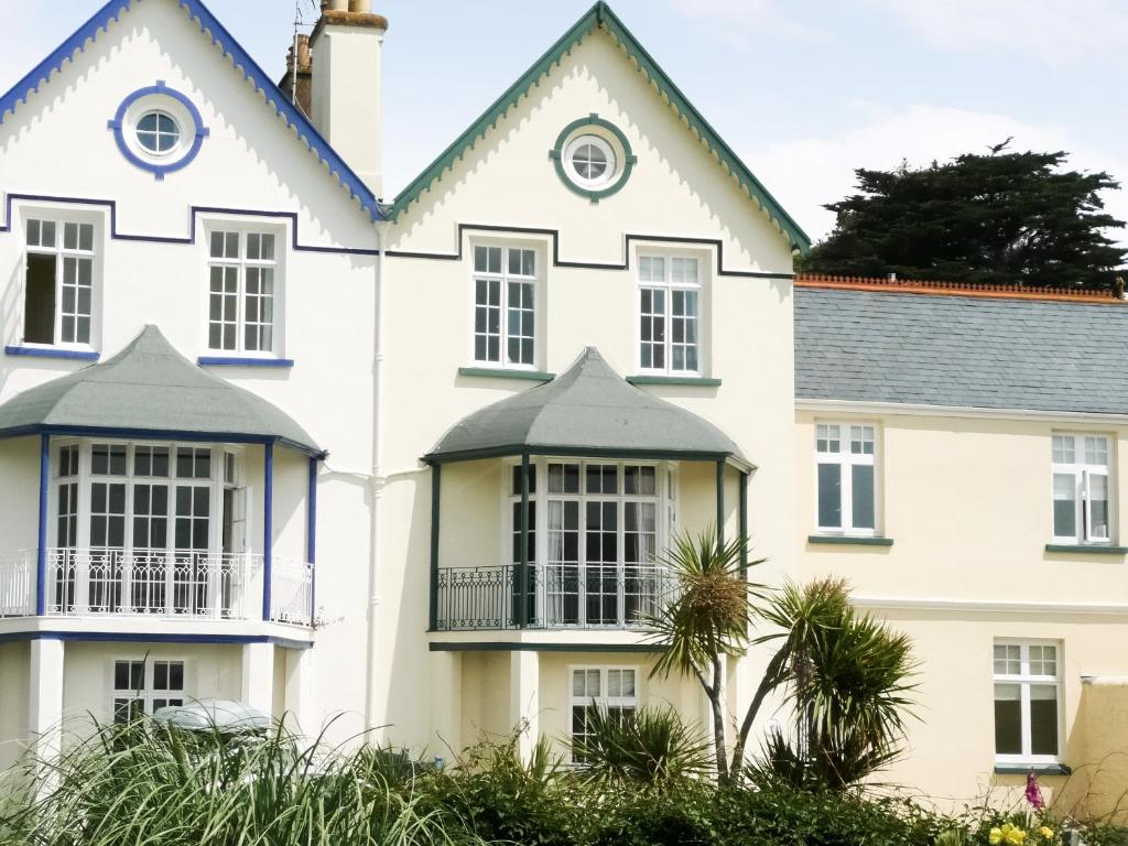 a large white house with a balcony at The Captains House in Instow