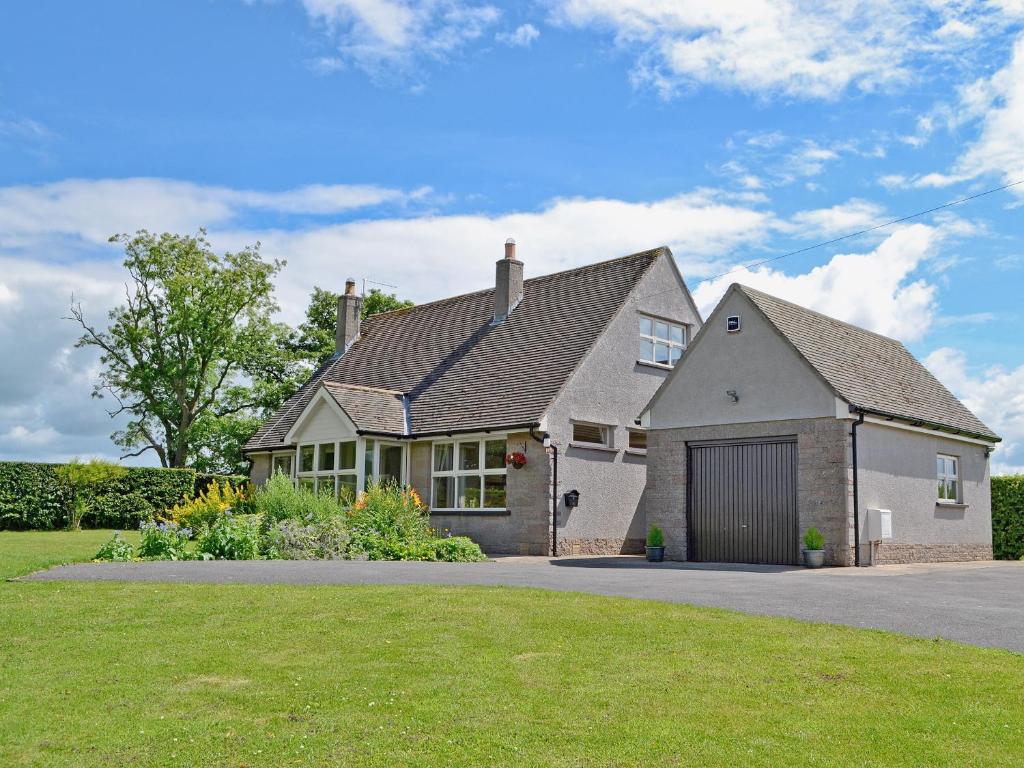 a house with a garage in a yard at Storrs Croft in Arkholme