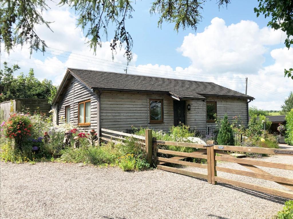 a house with a wooden fence in front of it at Challette At Timbertops in Washfield