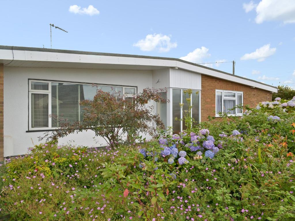 a house with flowers in front of it at Silverdale in Bacton