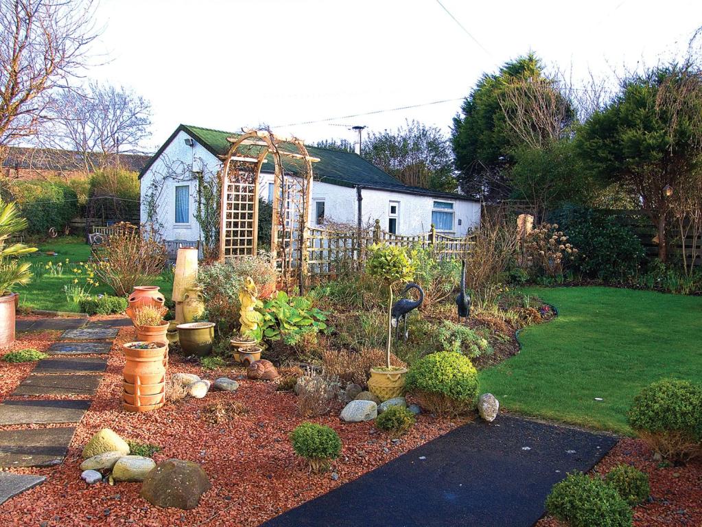 a garden with a fence and a house at Learig Cottage in Maidens