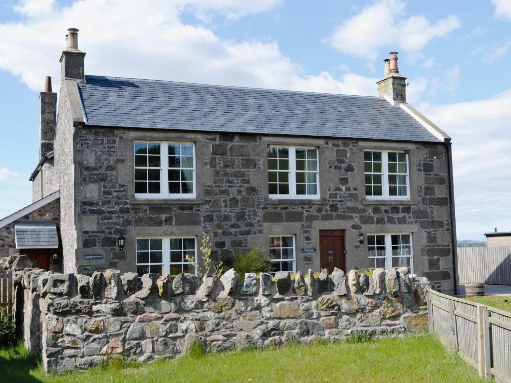 an old stone house with a stone wall at Meadowsweet in Newburgh