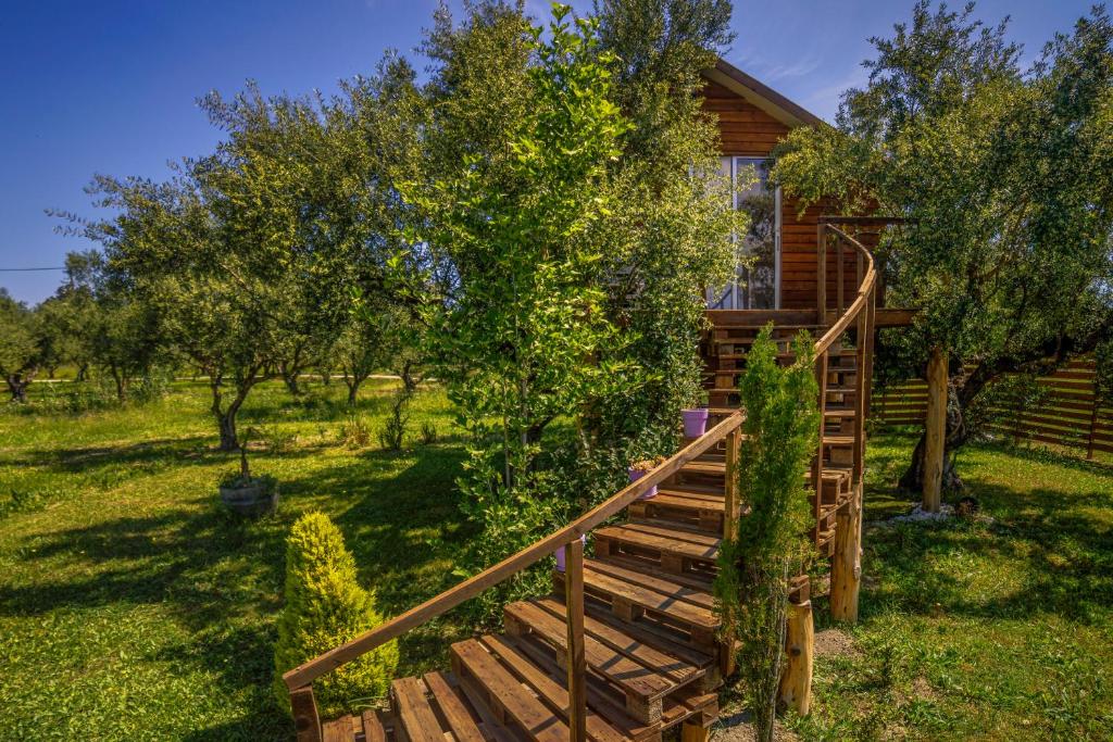 a wooden stairway leading to a cabin with trees at FairyTale in Koukounariá