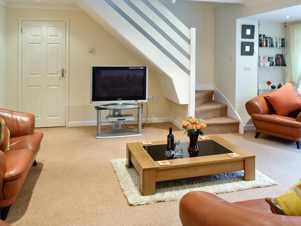 a living room with a tv and a coffee table at Riverside Cottage - B6859 in Saint Cleer