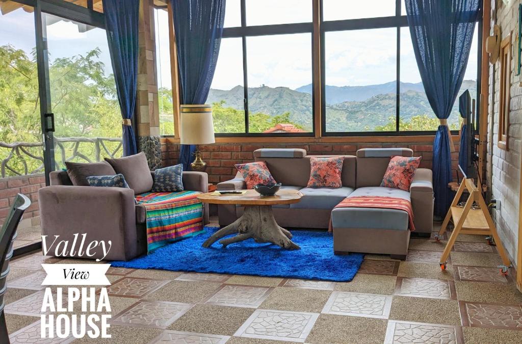 a living room with a couch and a table at Alpha House in Vilcabamba