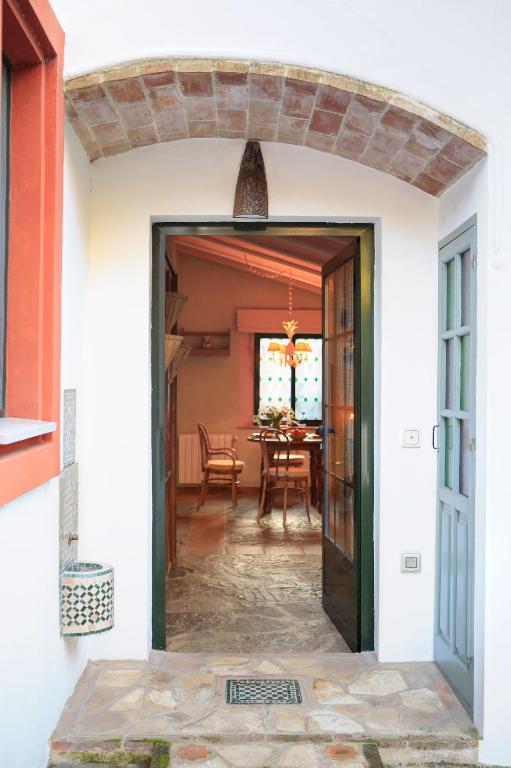 an open door into a dining room with a table at Cortijo La Hoya in El Bujeo