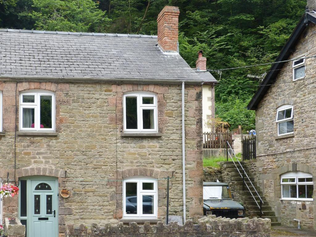 an old stone house with a blue door at The Briars in Lydbrook