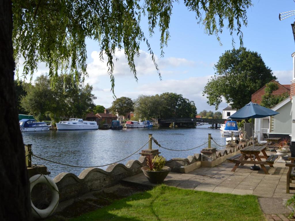a view of a river with boats in the water at Riverside House in Beccles