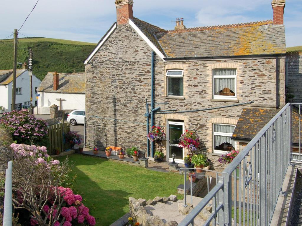 a brick house with a garden in front of it at Atlantic House - 27665 in Port Isaac