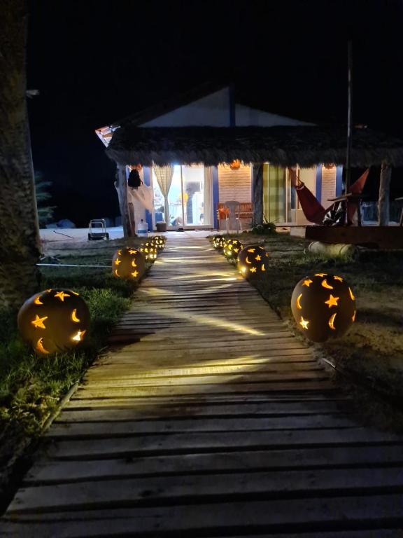 einen Weg, der nachts zu einem Haus mit Lichtern führt in der Unterkunft Chalé MAAR in Itarema