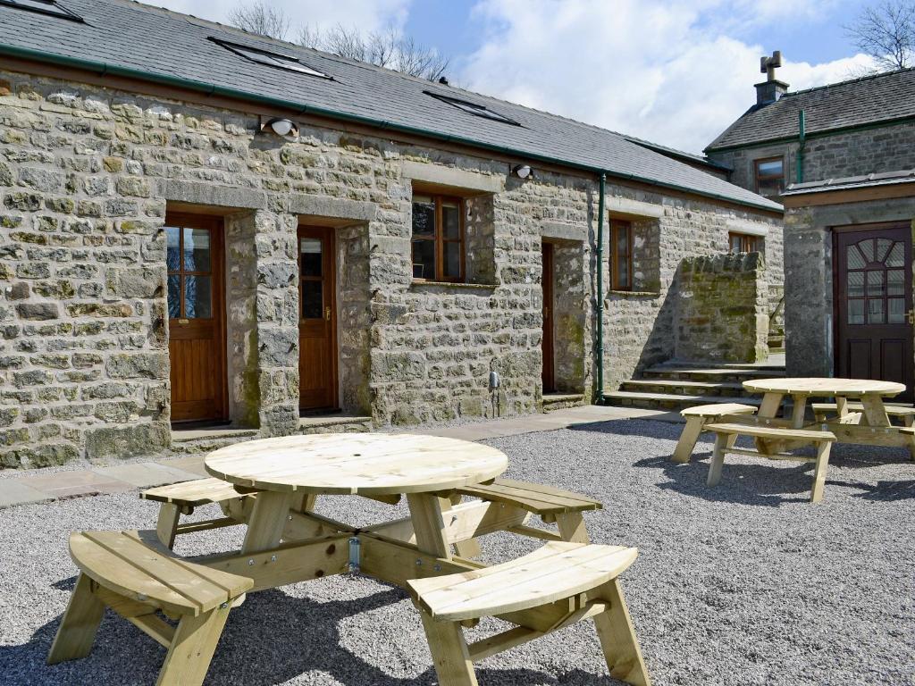 two picnic tables in front of a brick building at Valley View - 29530 in Scotforth