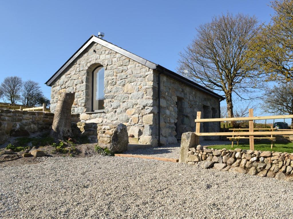 a stone church with a bench in front of it at The Granary in Criccieth