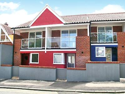 a red brick house on the side of a street at The Retreat in Cromer